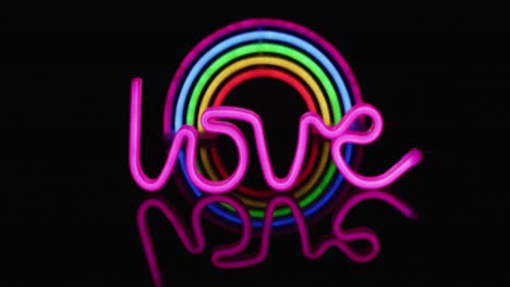 Animation-of-pink-neon-lights-forming-love-text-over-rainbow-on-black-background