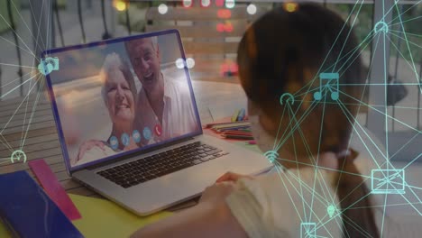 Animation-of-network-of-connections-with-icons-over-senior-caucasian-couple-having-laptop-video-call