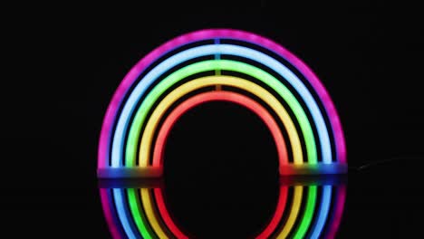 Animation-of-colorful-neon-lights-forming-rainbow-on-black-background
