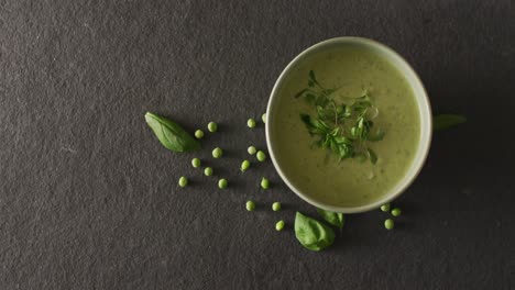 Video-of-green-peas-soup-in-bowl-on-grey-table