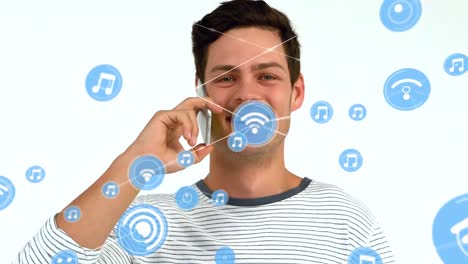Animation-of-network-of-connections-with-icons-over-caucasian-man-talking-on-smartphone