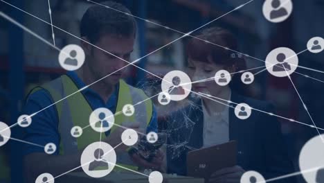 Animation-of-network-of-connections-with-icons-over-caucasian-workers-in-warehouse