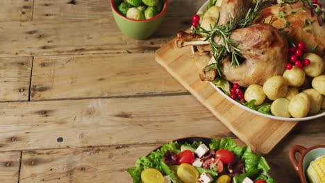 Video-of-tray-with-roasted-turkey,-potatoes-and-vegetables-on-wooden-surface