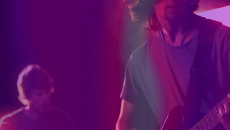 Animation-of-coloured-light-waves-over-two-caucasian-men,-one-playing-electric-guitar