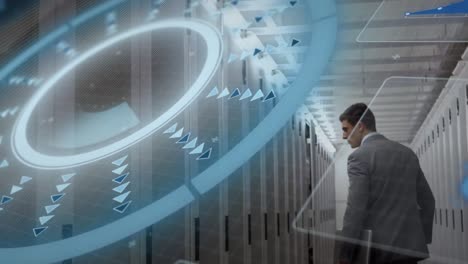 Animation-of-scanner-processing-data-over-caucasian-businessman-walking-through-server-room
