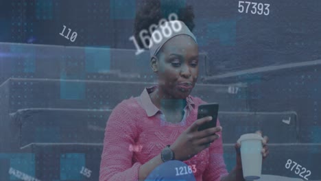 Animation-of-changing-numbers-over-african-american-woman-drinking-coffee-and-using-smartphone