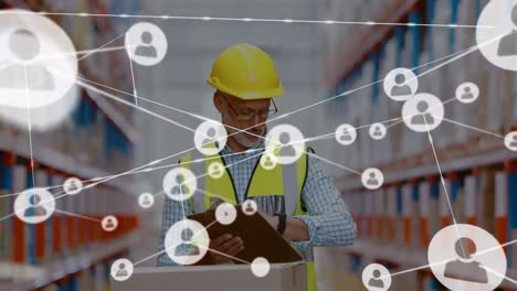 Animation-of-networks-of-connection-with-people-icons-over-caucasian-man-working-in-warehouse