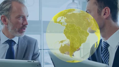 Animation-of-globe-over-caucasian-businessmen-using-tablet