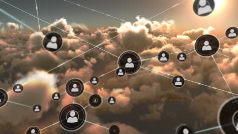 Animation-of-network-of-people-icons-exchanging-data-over-cloudy-sunset-sky