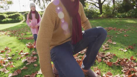 Video-of-happy-caucasian-father-piggybacking-daughter-in-sunny-autumn-garden