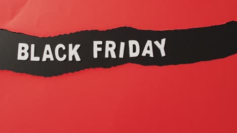 Black-friday-text-in-white-on-ripped-black-horizontal-stripe-on-red-background