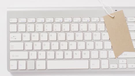 Overhead-view-of-brown-sale-tag-on-computer-keyboard
