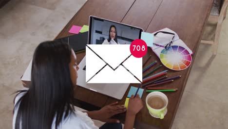 Animation-of-email-icon-with-numbers-over-caucasian-woman-on-laptop-video-call