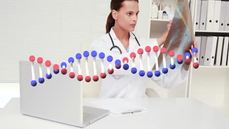 Animation-of-dna-structure-against-caucasian-female-doctor-examining-x-ray-report-at-hospital