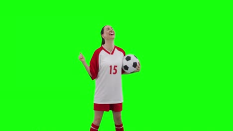 Video-Einer-Kaukasischen-Fußballspielerin,-Die-Fußball-Hält-Und-Platz-Auf-Einem-Grünen-Bildschirm-Kopiert