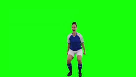 Video-of-caucasian-female-football-player-cheering-with-copy-space-on-green-screen