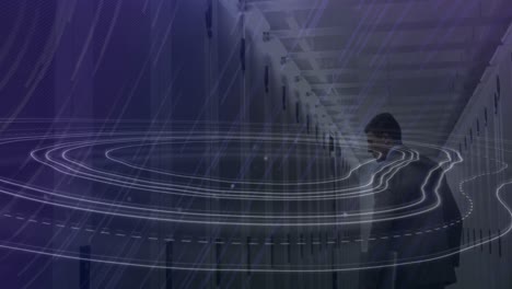 Animation-of-topography-and-light-trails-falling-over-male-engineer-walking-in-server-room