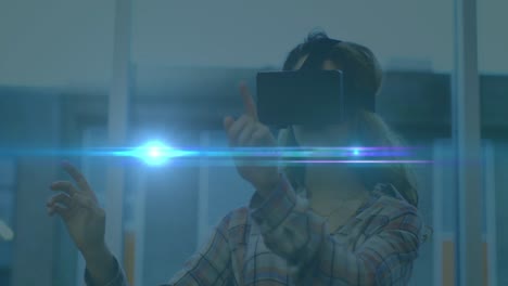 Animation-of-blue-light-spot-moving-over-caucasian-woman-wearing-vr-headset-at-office
