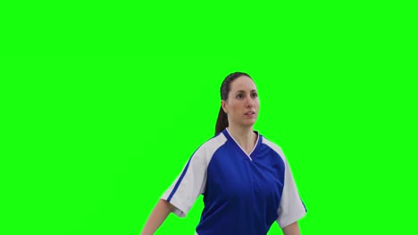 Video-of-caucasian-female-football-player-head-kicking-football-and-copy-space-on-green-screen
