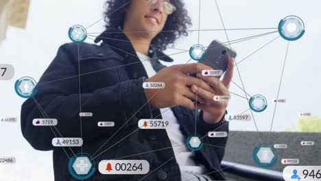 Animation-of-network-of-connections-and-icons-with-numbers-over-biracial-man-using-smartphone