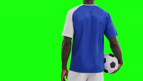 Video-of-mid-section-of-african-american-male-soccer-player-with-ball-on-green-screen-background