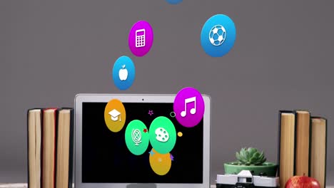 Animation-of-colorful-icons-over-laptop-on-desk
