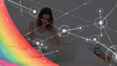 Animation-of-network-of-connections-over-caucasian-woman-using-laptop