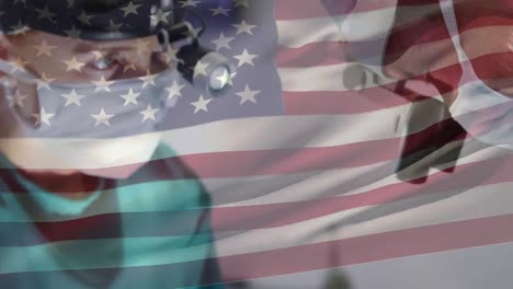 Composite-video-of-waving-us-flag-over-male-and-female-surgeons-performing-operation-at-hospital
