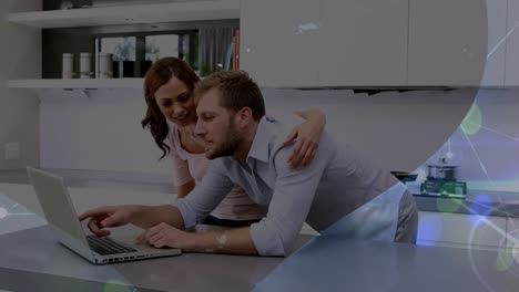 Animation-of-network-of-connections-with-light-spots-over-caucasian-couple-using-laptop