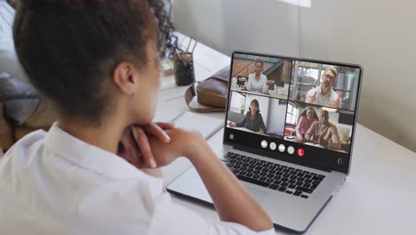 Animation-of-biracial-woman-having-video-call-on-laptop
