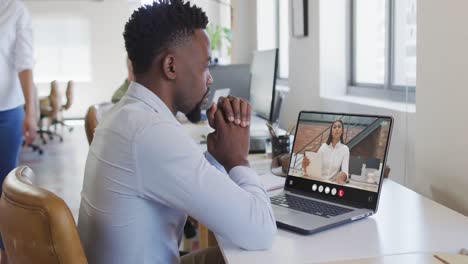 Animation-of-african-american-man-having-video-call-on-laptop