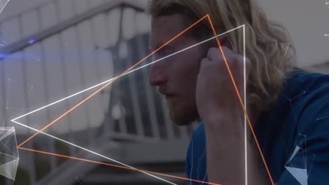 Animation-of-neon-triangular-shapes-over-close-up-of-caucasian-man-wearing-earphone-outdoors