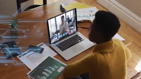 Animation-of-microprocessor-connections-over-african-american-woman-having-a-video-call-on-laptop