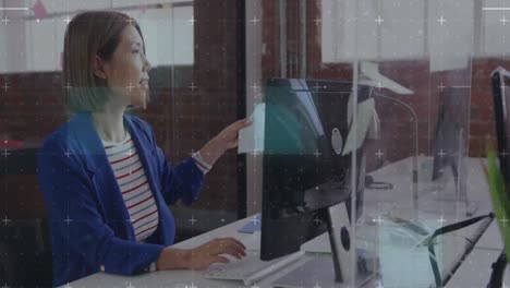 Animation-of-scanner-processing-data-over-happy-asian-businesswoman-passing-document-in-office