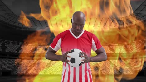 Animation-of-stadium-and-flames-over-african-american-male-soccer-player