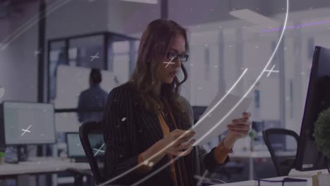 Animation-of-scanner-processing-data-over-caucasian-businesswoman-reading-document-in-office
