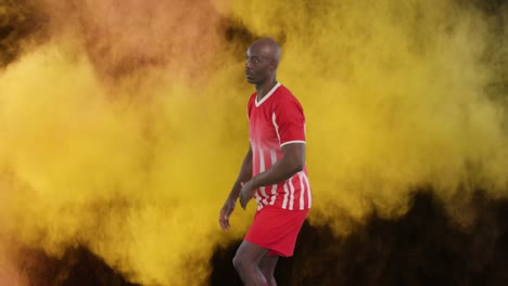 Animation-of-smoke-trails-over-african-american-male-soccer-player-playing