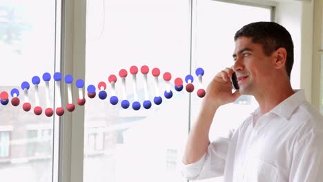 Animation-of-dna-strand-spinning-over-business-people-using-digital-devices