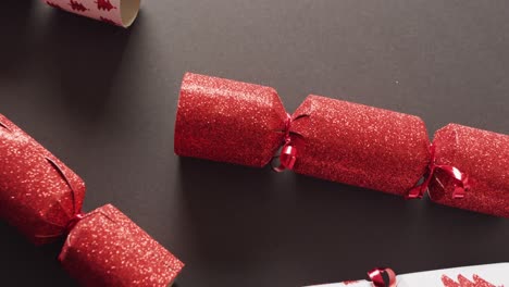 Video-of-red-and-white-christmas-crackers-on-grey-background