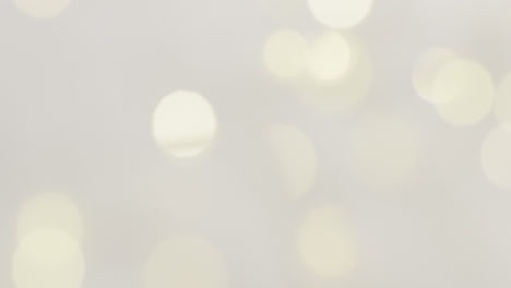 Video-of-close-up-of-bokeh-christmas-fairy-lights-on-grey-background