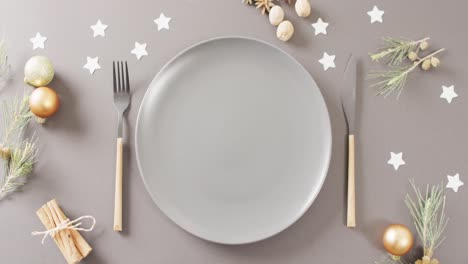 Video-of-christmas-place-setting-with-cutlery-on-grey-background