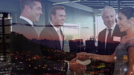Animation-of-caucasian-business-people-shaking-hands-over-cityscape