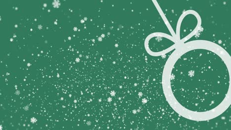 Animation-of-snowflakes-and-bauble-on-green-background