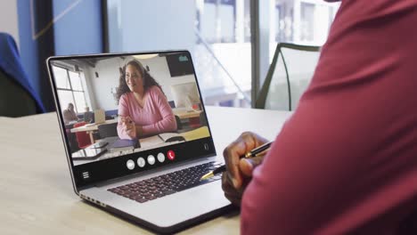 African-american-man-using-laptop-for-video-call,-with-business-colleague-on-screen