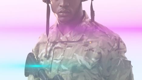 Animation-of-portrait-african-american-army-solider-holding-gun-and-multicolored-moving-lens-flare