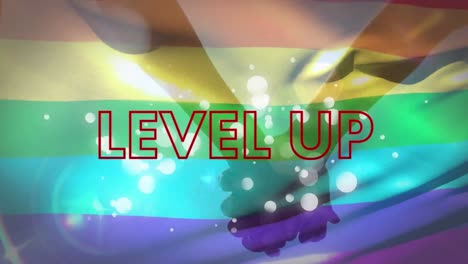 Animation-of-level-up-text-with-red-shapes-over-lgbt-flag-and-people-holding-hands