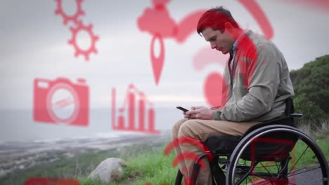 Animation-Von-Symbolen-über-Einem-Behinderten-Kuakasischen-Mann,-Der-Im-Rollstuhl-Sitzt-Und-Sein-Smartphone-Benutzt