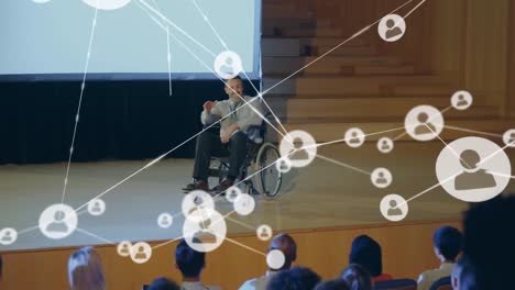 Animation-of-network-of-connections-over-caucasian-man-in-wheelchair-at-meeting