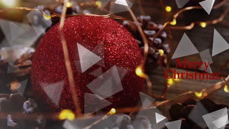 Animation-of-shapes-over-merry-christmas-text-and-decorations