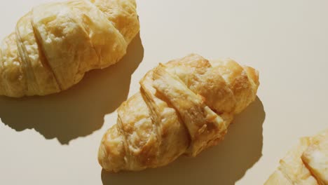 Video-of-close-up-of-croissants-with-copy-space-on-white-background